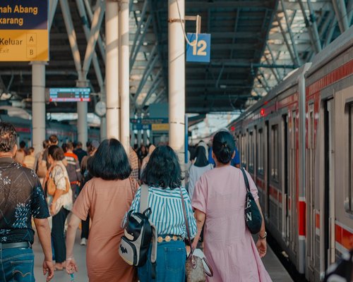 Commuters waiting for public transport at a bright modern train station in Jakarta